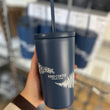 Load image into Gallery viewer, A hand holding out the blue mug with flowers on it
