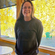 Load image into Gallery viewer, Smiling girl in a dark grey sweatshirt with fall leaves in the background