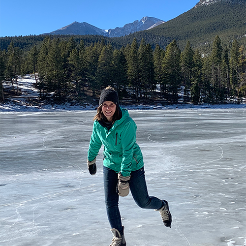 a woman ice skating in the mountains