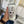 Load image into Gallery viewer, A person&#39;s hand holding out a white mug with a modern mountain, tree, and water design
