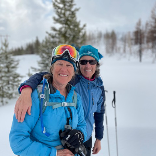 two women dressed in outdoor clothes in the snow