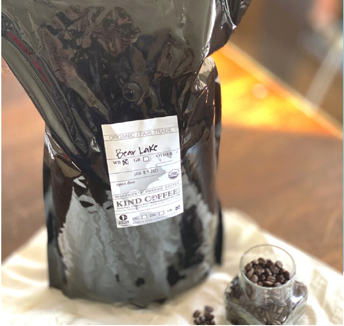 a black 5 lb bag of coffee with a white label 