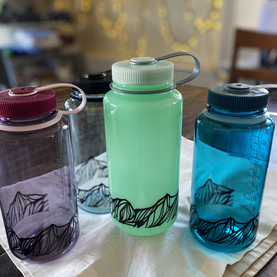 Four Nalgene Waterbottles on a table