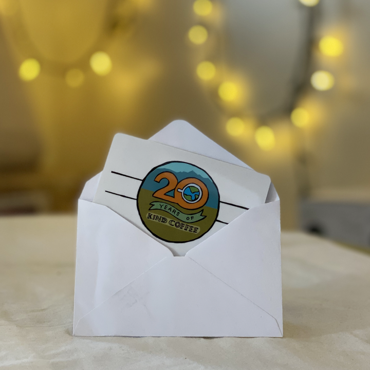 white envelope with Kind Coffee gift card with logo of "20 years of Kind Coffee"