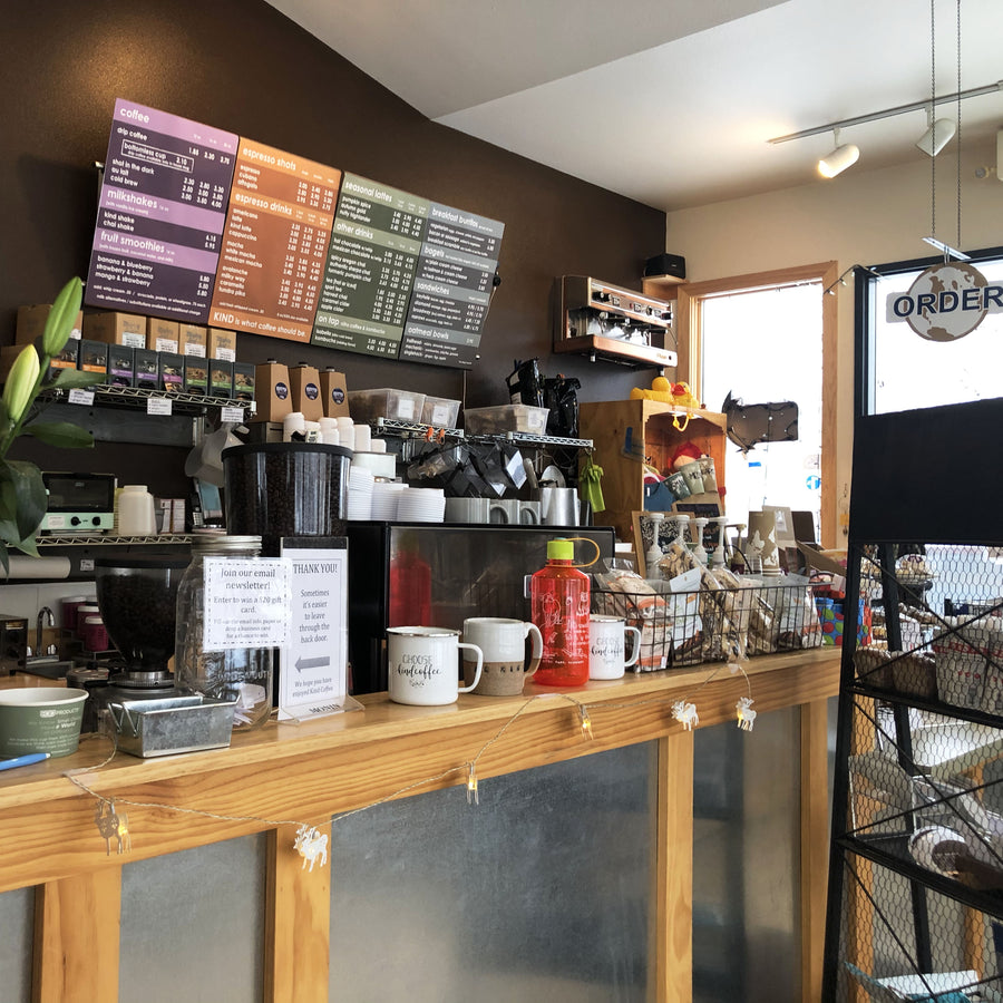 image of inside the Kind Coffee shop showing the menu and back of espresso machine. 