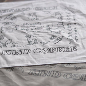 Closeup of white bandana showing "Kind Coffee" logo