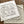 Load image into Gallery viewer, White and gray Let&#39;s Wander Bandanas. Design says &quot;Let&#39;s wander where the Wifi is weak and the coffee is strong&quot; in center with local animal sketches, and Kind Coffee - Estes Park, Colorado around the border. 
