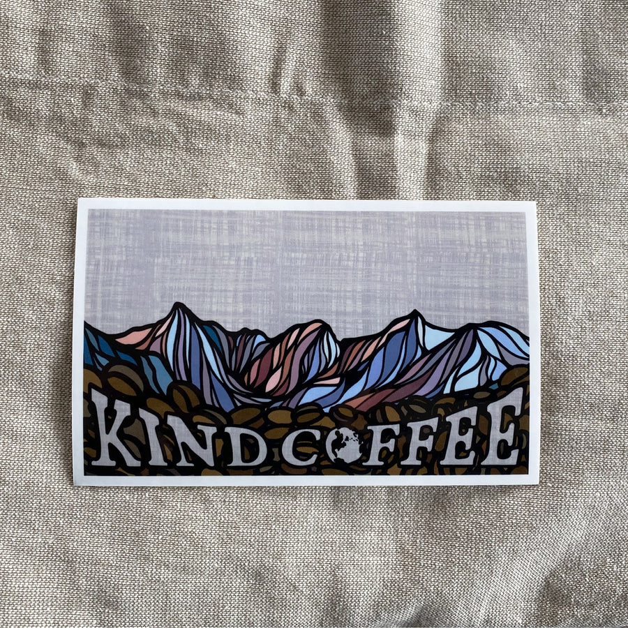 Mountain Sticker with a colorful mountain background, espresso beans, and "Kind Coffee" in the foreground