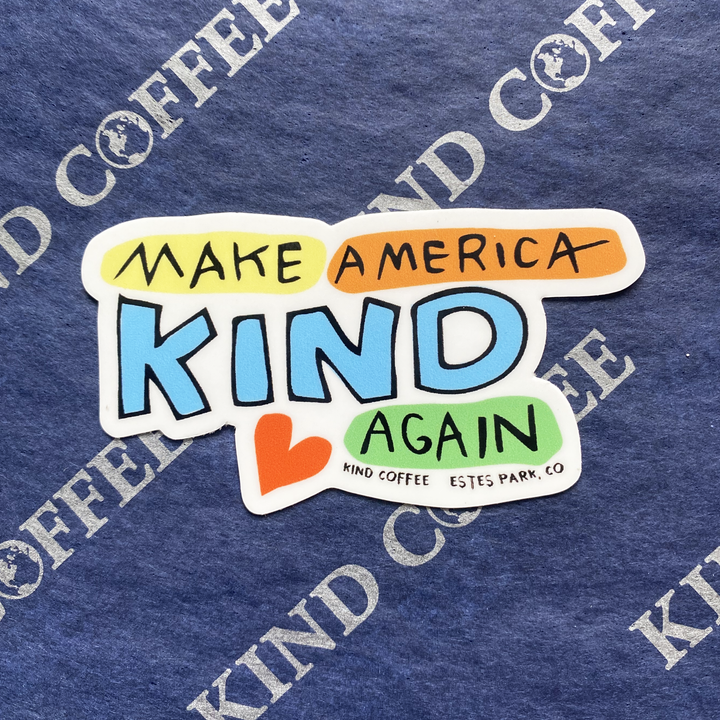 Colorful sticker that reads "Make America Kind Again" with a heart below it.